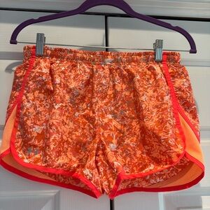 Women’s Under Armour size small orange shorts.
